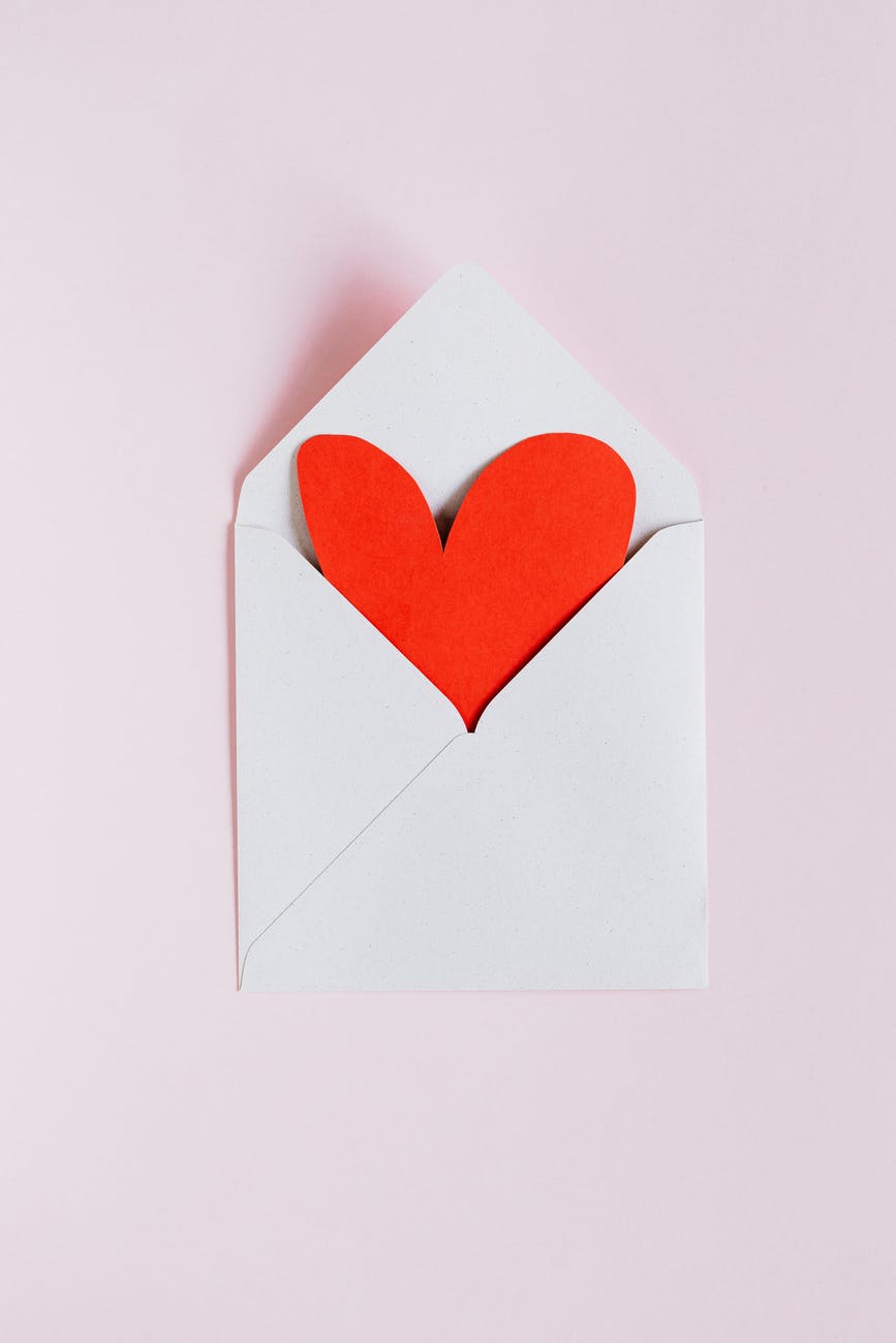 white envelope with red paper heart