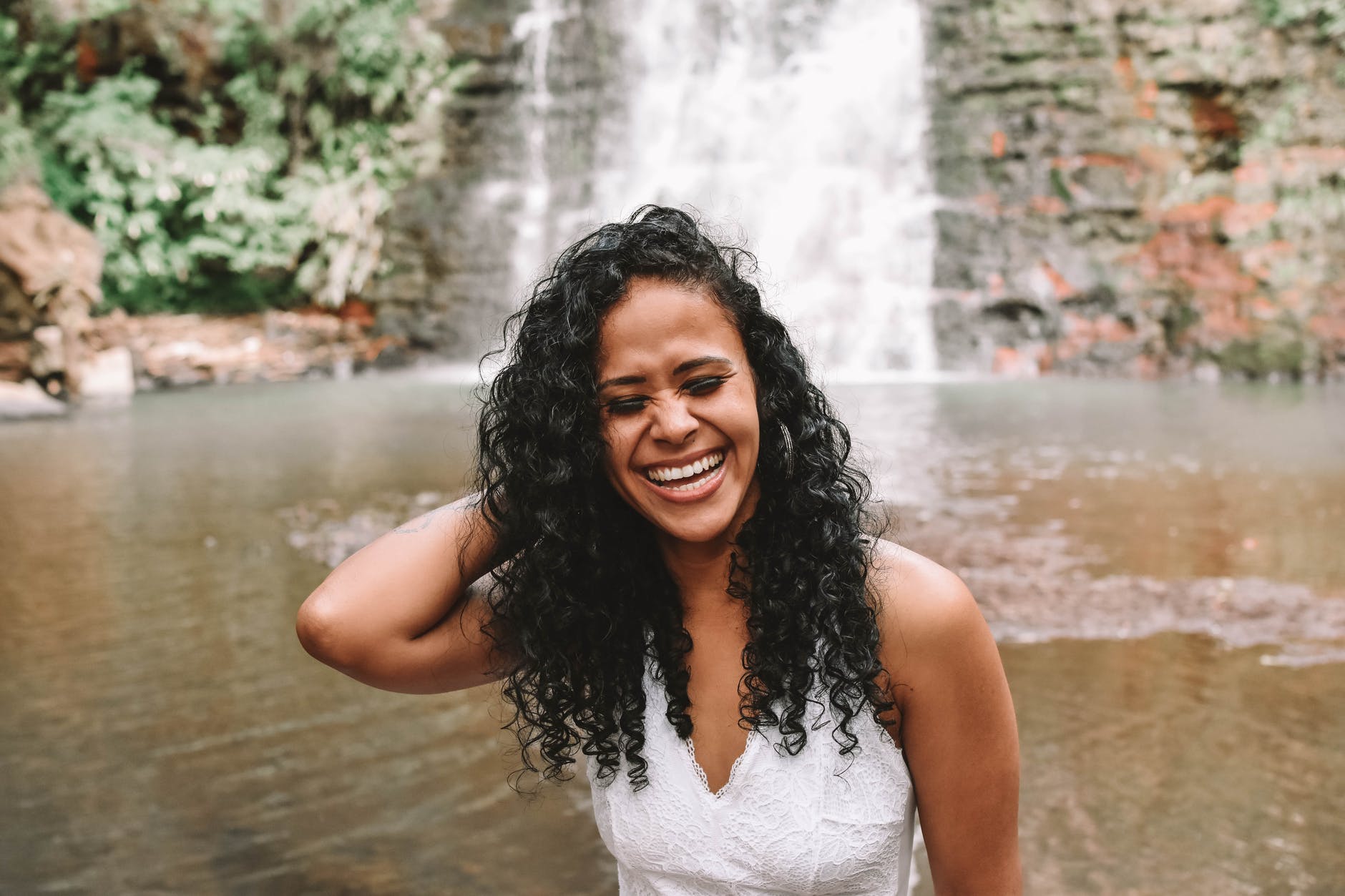 happy black woman near waterfall